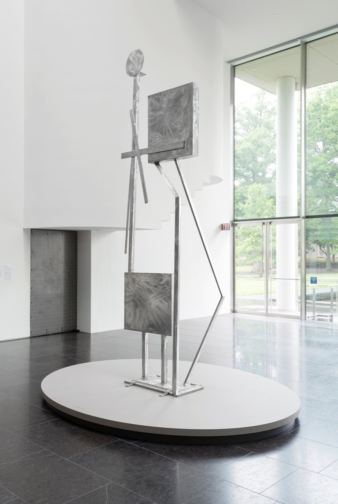 Photo: David Stover © Virginia Museum of Fine Arts May 22, 2015 David Smith: L2015.5 Here and Above: A Dialogue Between Sculptures Through March 2016 A year-long installation in the museum’s atrium, Here and Above situates two welded steel sculptures in a cross-generational dialogue about material, form, and the environment. Rising from the ground in a delicate balance, Two Box Structure reads as a vertical composition of geometric shapes, while also suggesting human figures. Extending from the wall overhead, Noctilucent Clouds offers a literal model of luminous, thin clouds located in the most distant part of the atmosphere, while also reading as a dynamic composition of lines in space. Rebecca Smith (b.1954), the daughter of Abstract Expressionist sculptor David Smith (1906–1965), spent her early childhood in the New York hamlet of Bolton Landing, playing in the fields amid dozens of her father's sculptures. Here the works of these two artists respond to one another as natural light activates their surfaces, drawing the surrounding space into the conversation. Rebecca Smith American, born 1954 Noctilucent Clouds, 2015 Stainless steel, interference acrylic paint On loan from Rebecca Smith, courtesy Waqas Wajahat David Smith American, 1906-1965 Two Box Structure, 1961 Stainless steel On loan from Philadelphia Museum of Art: Gift of Paul and Hope Makler, 1972