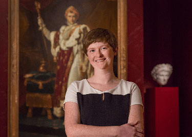 Dr. Colleen Yarger Standing in front of a Painting of Napoleon
