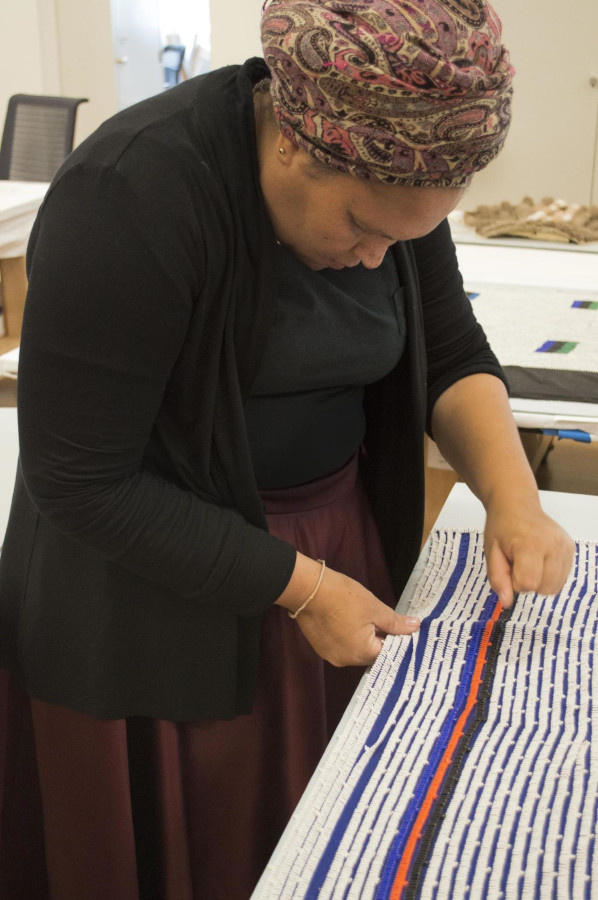 Hlendiwe Dube executing a repair with a traditional knotting stitch on a man’s beaded shawl (2013.195a, obverse). VMFA. May 31, 2017.