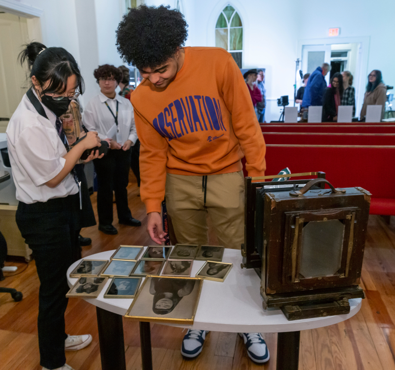 Attendees check out M.LiT-organized photography displays at Oakwood Arts.