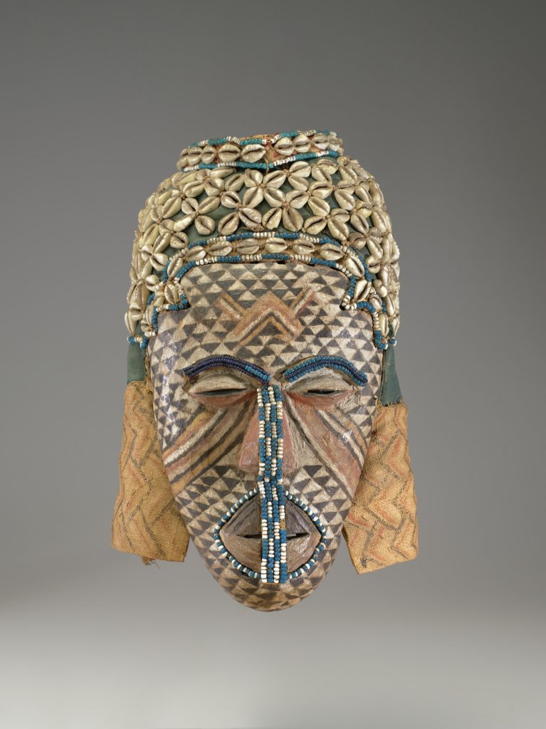 Ngady amwaash Mask,19th-20th c., Kuba culture Democratic Republic of Congo, wood, paint, cloth, cowrie shells, glass beads, string. Arthur and Margaret Glasgow Fund, 87.83