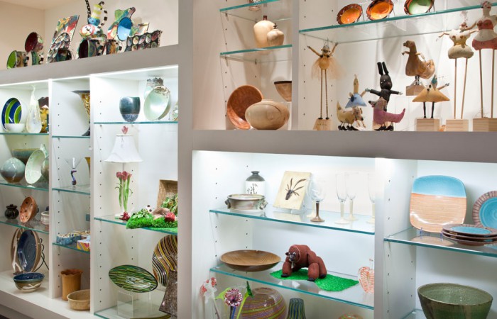 A selection of bowls, vases, and sculptures on shelves in the VMFA Shop.