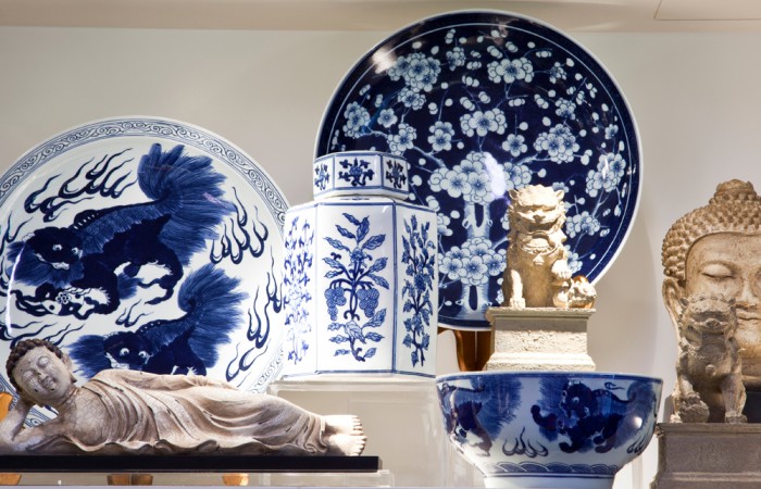 A selection of plates, bowls, and statues on a shelf in the VMFA Shop.