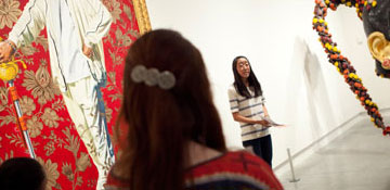 Student giving presentation in gallery